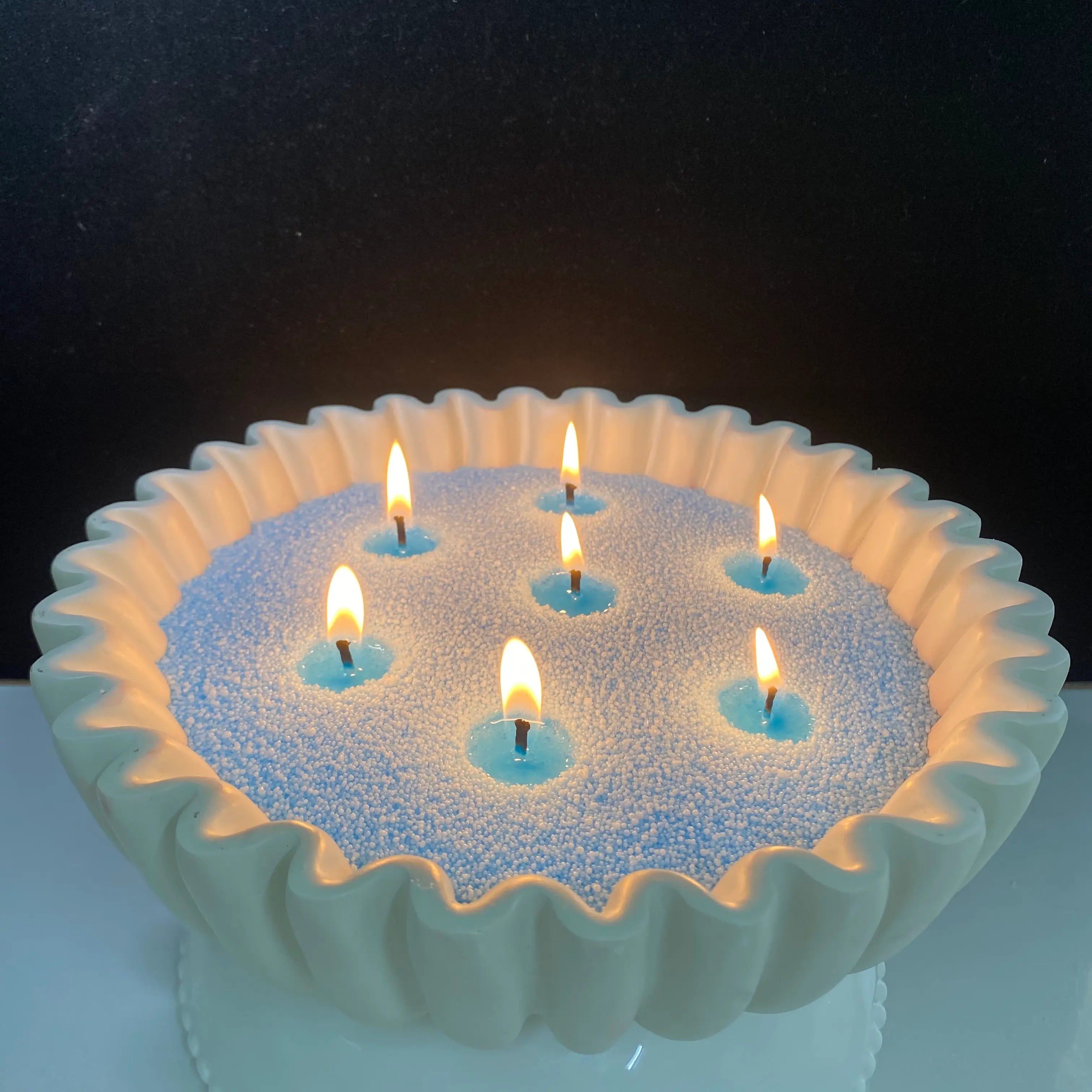 Baby Blue pearled candle wax in a white shell-shaped candle bowl with multiple warm flames.