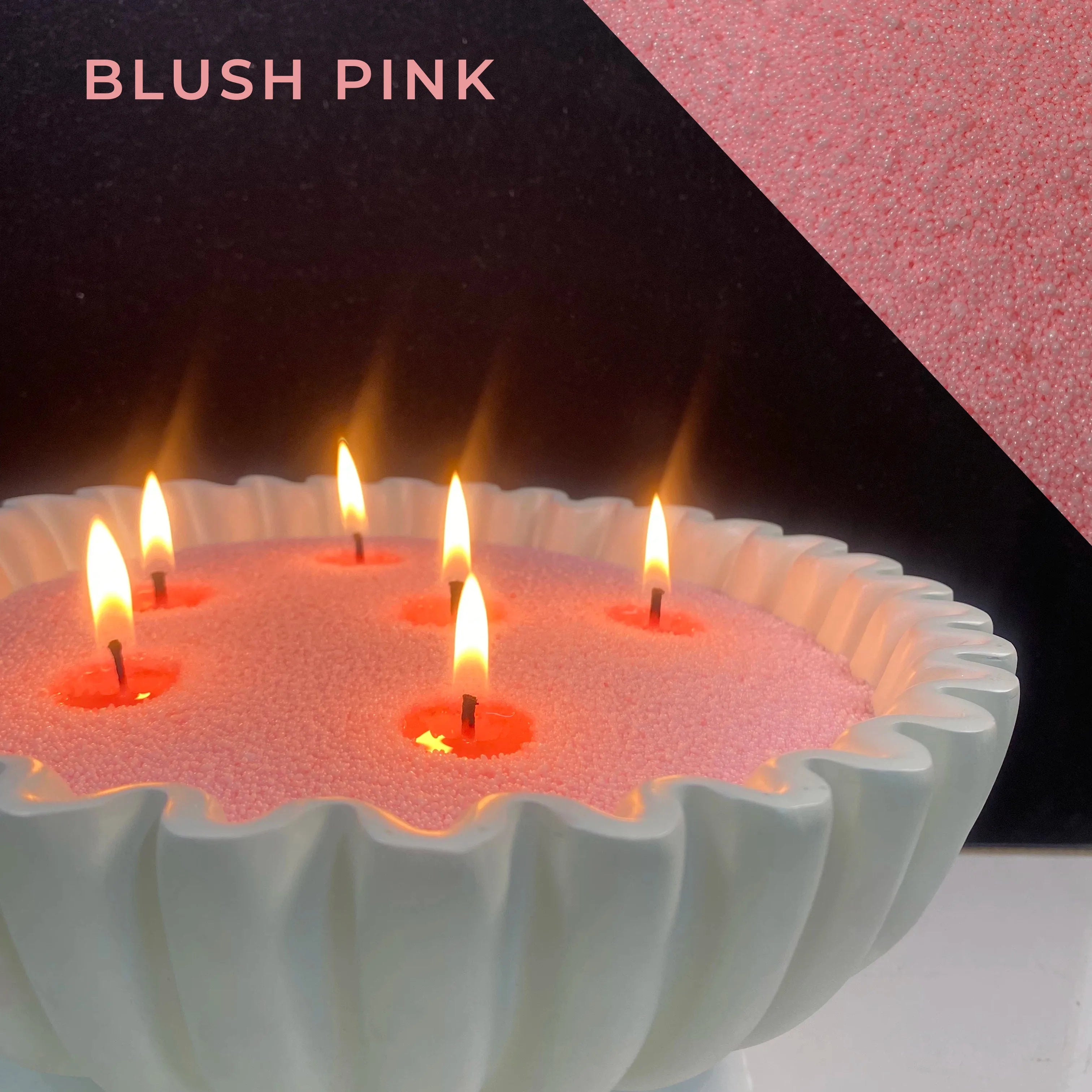close-up of blush pink pearled candle wax with a clean flame and visible wax pearls