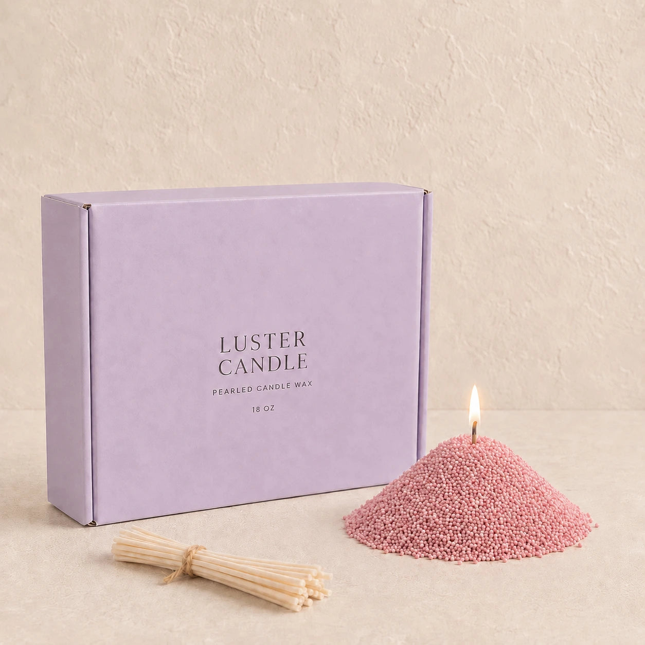 Blush Rose Scented Pearled Candle Wax with lavender purple Luster Candle box, pearled candle wax mound, cotton wick bundle, and soft flame.