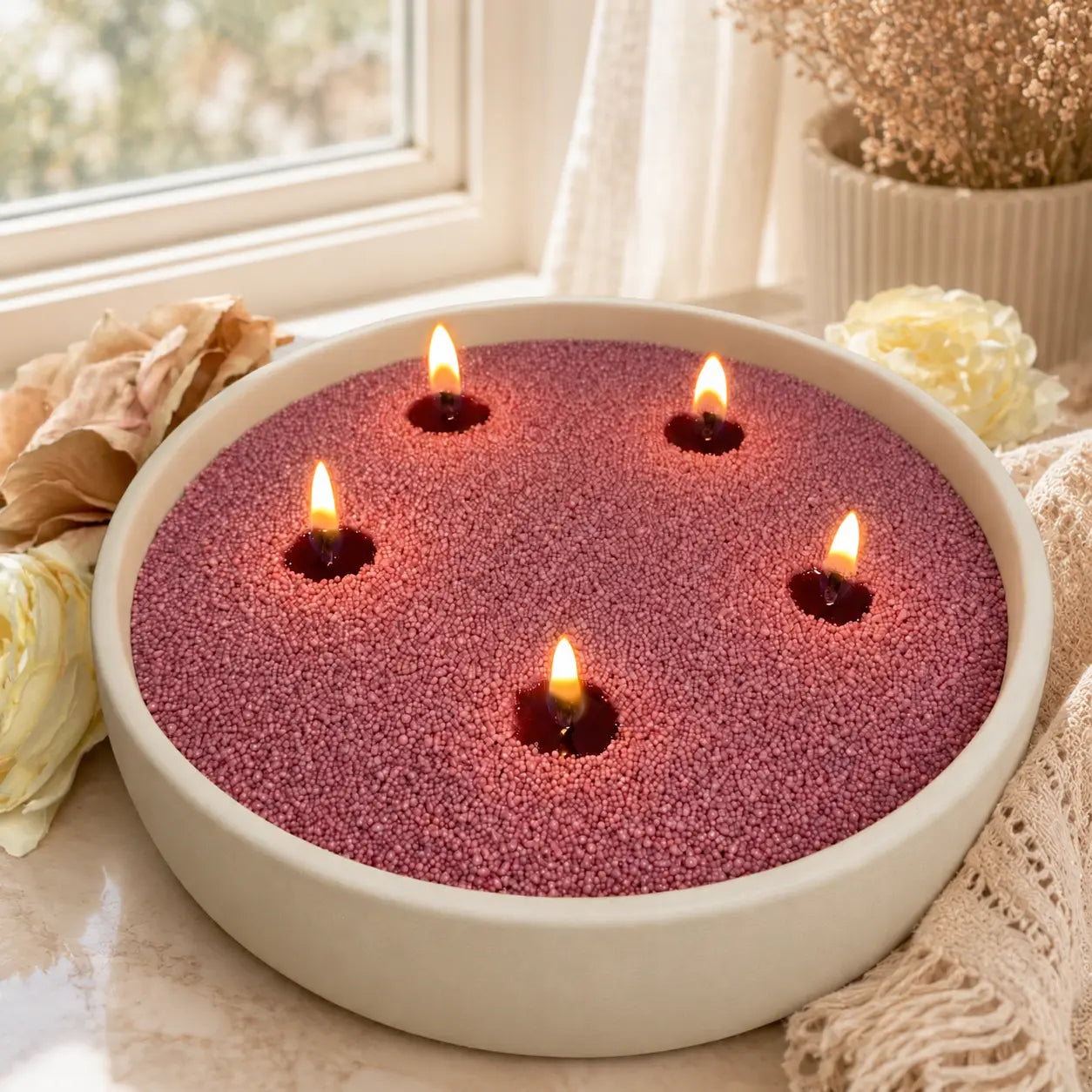 Desert Rose pearled candle wax in a warm ivory ceramic bowl placed in an elegant window-side lifestyle scene.