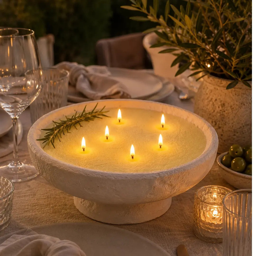 Lemon Yellow pearled candle wax styled in a large stone bowl as a warm dinner table centerpiece with multiple lit wicks.