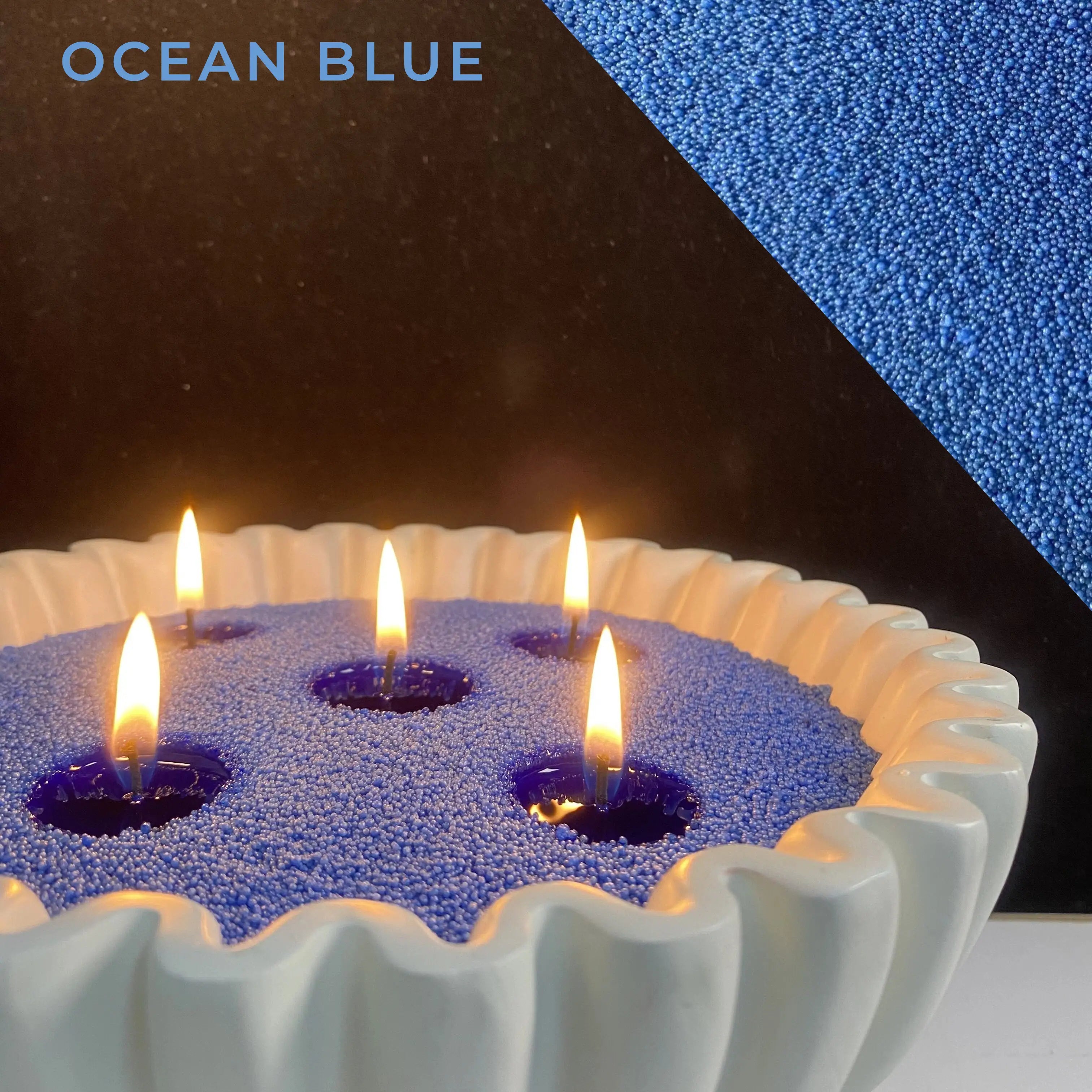close-up of ocean blue pearled candle wax with a clean flame and visible wax pearls