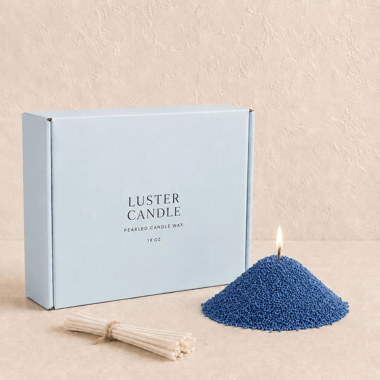Ocean Blue Pearled Candle Wax with milk blue Luster Candle box, pearled candle wax mound, cotton wick bundle, and soft flame.