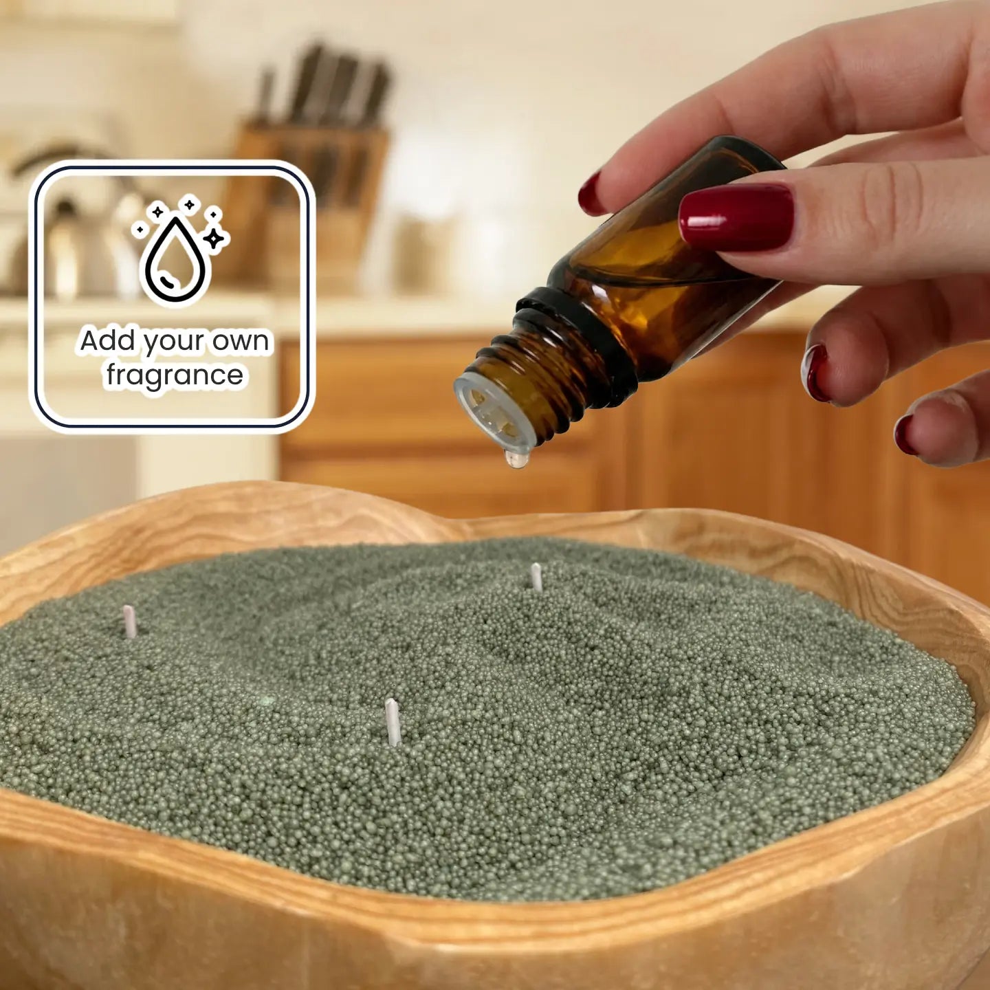 Fragrance oil being added to pearled candle wax for a customizable scented refillable candle experience.