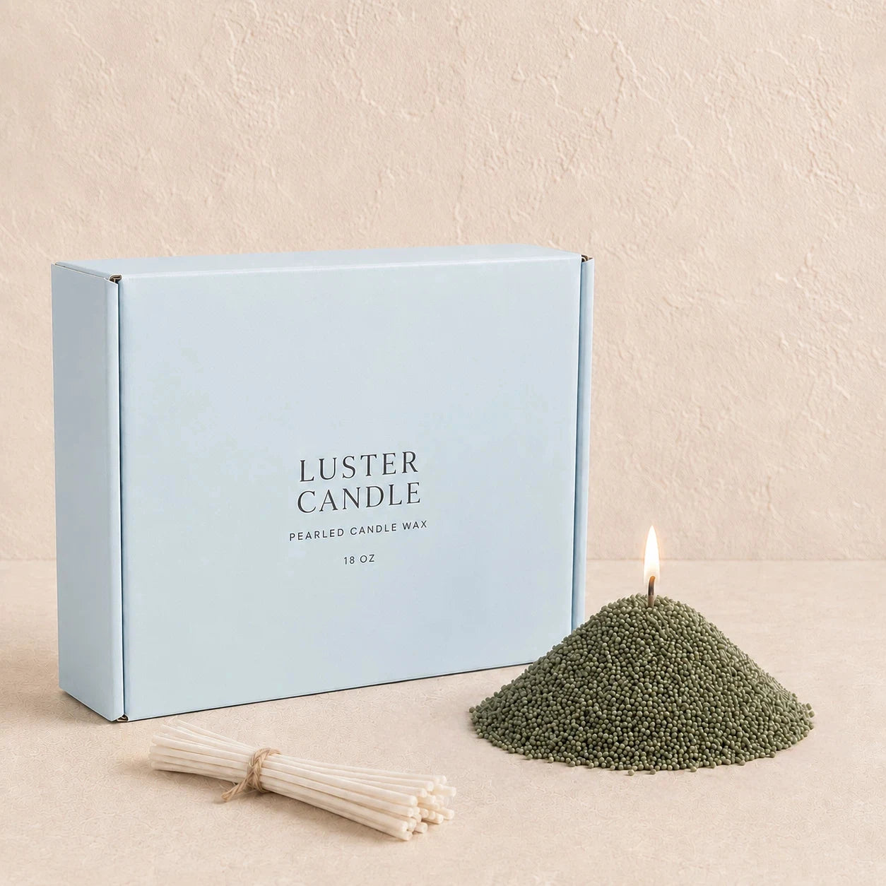 Sage Green Pearled Candle Wax with milk blue Luster Candle box, pearled candle wax mound, cotton wick bundle, and soft flame.