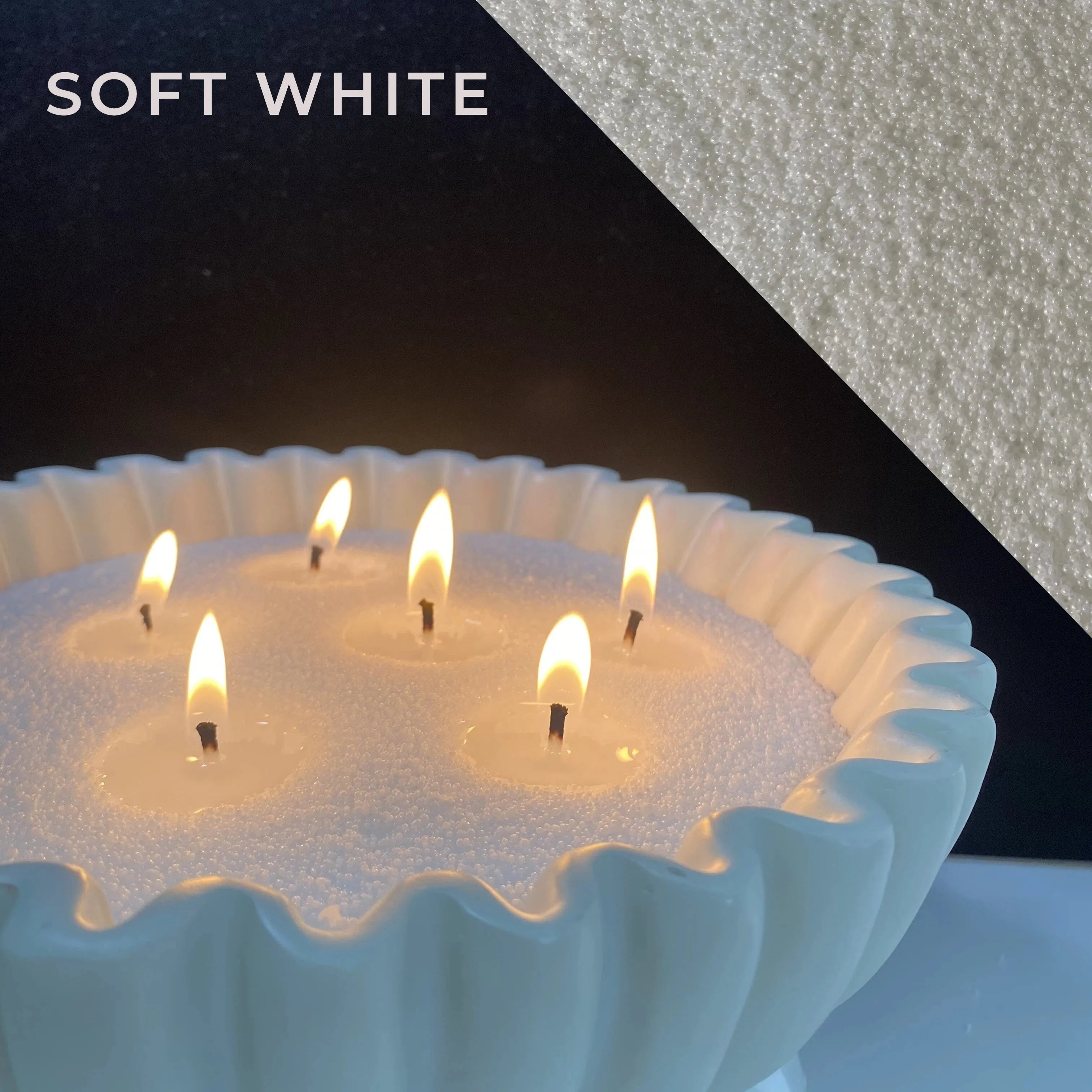 close-up of soft white pearled candle wax with a clean flame and visible wax pearls
